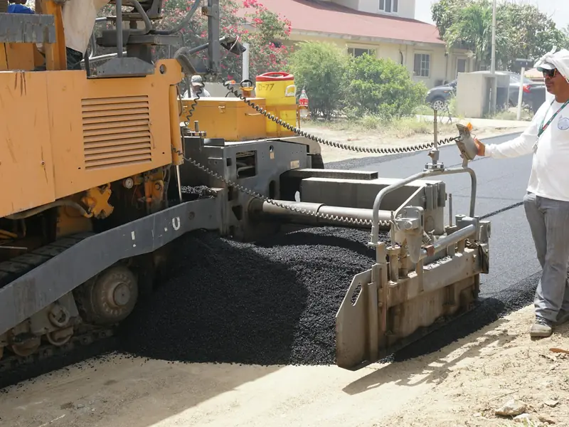 Stock photo: road maintenance crew operating an asphalt paving machine